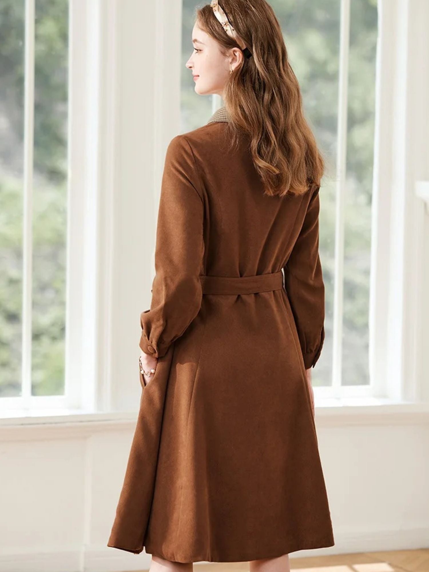 Back view of brown dress showing belt detail and soft pleats.